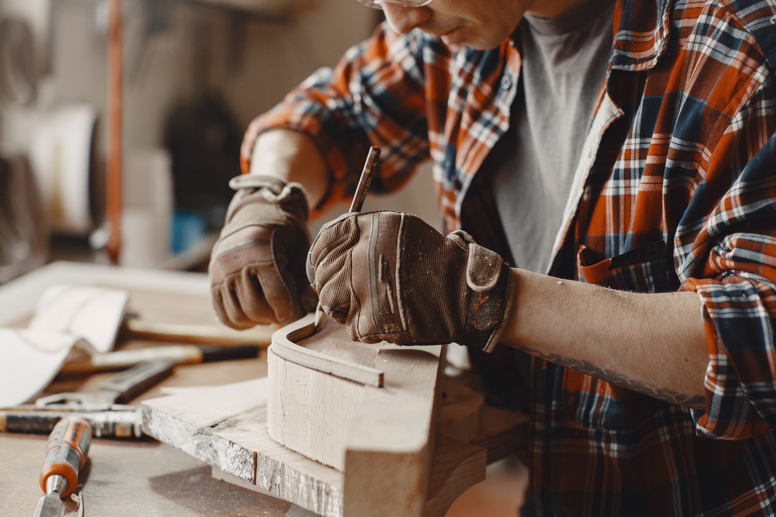 Man in the workshop with a wood